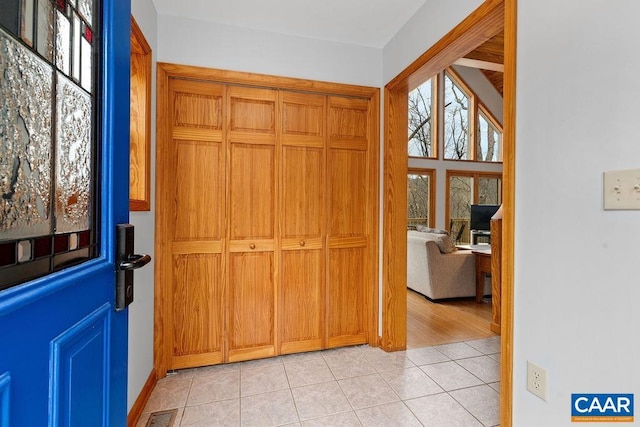 foyer entrance featuring light tile patterned floors and visible vents
