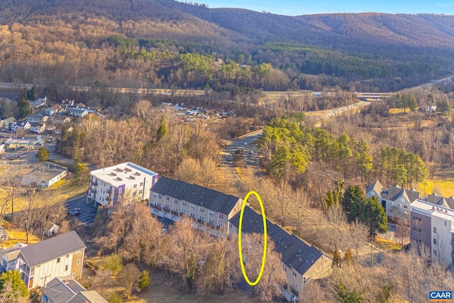 drone / aerial view featuring a mountain view and a view of trees
