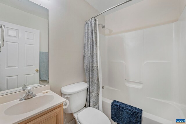 full bath featuring toilet, shower / tub combo with curtain, and vanity