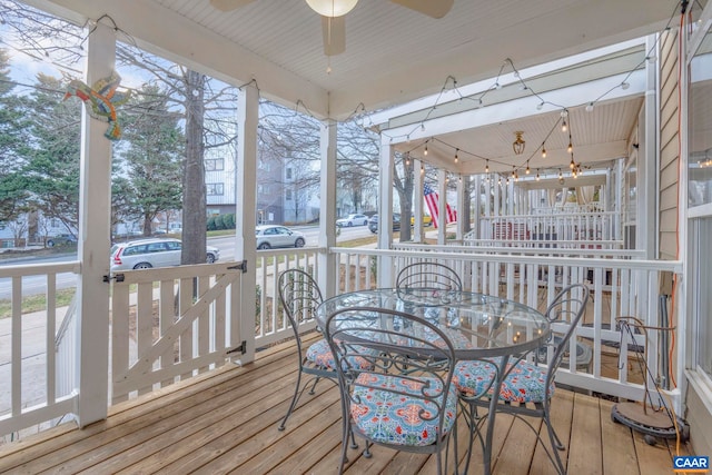 sunroom with outdoor dining space and a ceiling fan