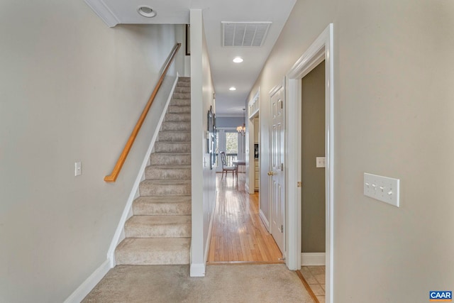 stairway featuring baseboards, recessed lighting, carpet flooring, and visible vents