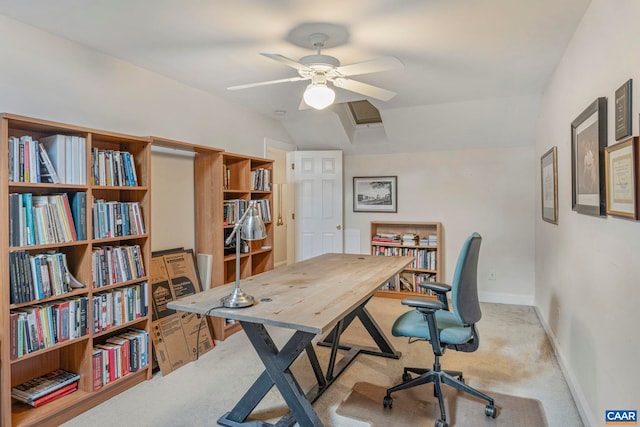 carpeted home office featuring baseboards, lofted ceiling, and ceiling fan