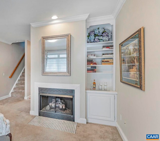 interior space featuring crown molding, baseboards, a fireplace with flush hearth, and stairs