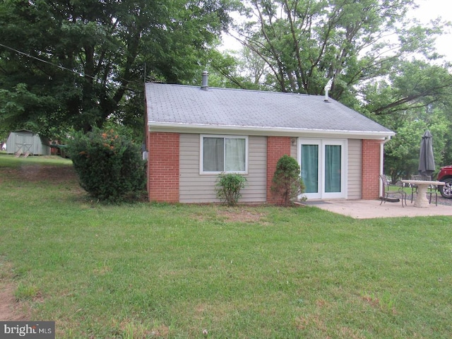 831 Good Mill Rd, Rileyville, VA 22650 - back of property featuring a shed, a patio area, brick siding, an outdoor structure, and a yard
