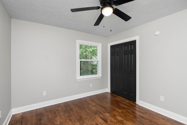 91 Cooper Dr, Stuarts Draft, VA 24477 - unfurnished bedroom featuring dark wood-style flooring, a closet, baseboards, a textured ceiling, and a ceiling fan