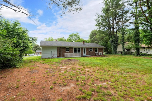 91 Cooper Dr, Stuarts Draft, VA 24477 - rear view of property with a chimney, brick siding, and a yard