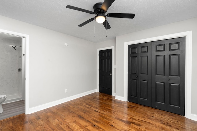 91 Cooper Dr, Stuarts Draft, VA 24477 - unfurnished bedroom featuring wood finished floors, baseboards, a closet, ensuite bath, and a textured ceiling