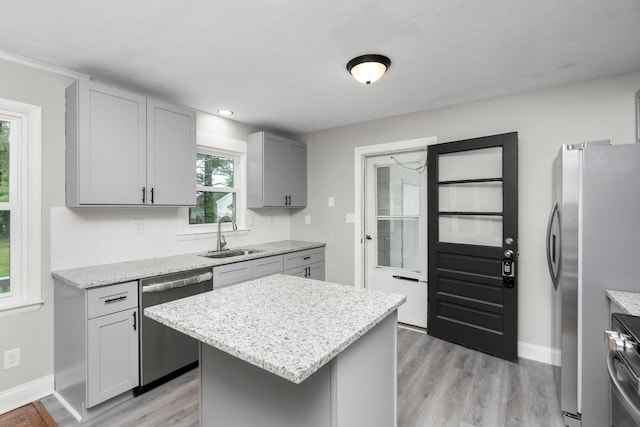 91 Cooper Dr, Stuarts Draft, VA 24477 - kitchen with stainless steel appliances, a sink, light wood-style floors, light stone countertops, and baseboards