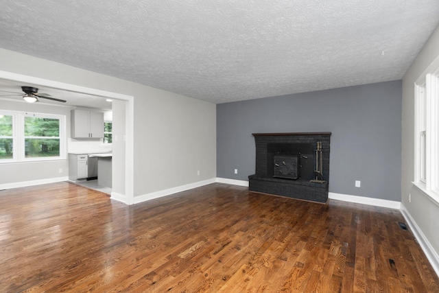 91 Cooper Dr, Stuarts Draft, VA 24477 - unfurnished living room with dark wood finished floors, a textured ceiling, ceiling fan, a fireplace, and baseboards