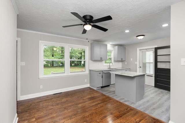 91 Cooper Dr, Stuarts Draft, VA 24477 - kitchen with gray cabinetry, dishwasher, a sink, light wood-style floors, and a kitchen island