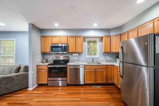 392 Passage Ln, Mcgaheysville, VA 22840 - kitchen featuring appliances with stainless steel finishes, a sink, light countertops, light wood-style flooring, and recessed lighting