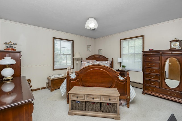 bedroom with light carpet, multiple windows, and baseboard heating
