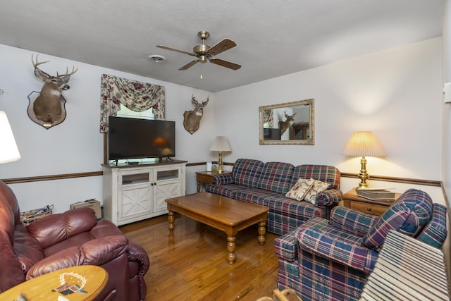 living area with ceiling fan and wood finished floors