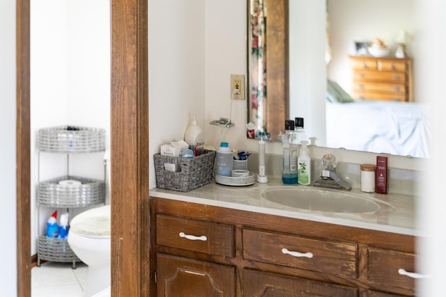 bathroom featuring vanity, toilet, and tile patterned floors