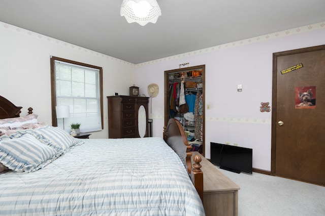 carpeted bedroom featuring a spacious closet, a closet, and baseboards