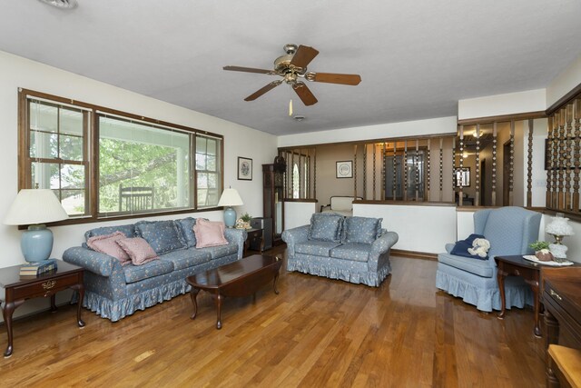 living room with wood finished floors and ceiling fan
