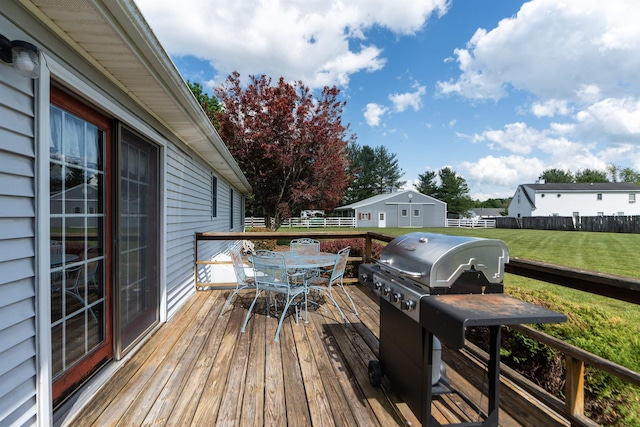wooden terrace with outdoor dining space and a grill