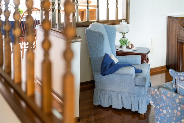 sitting room with baseboards and wood finished floors