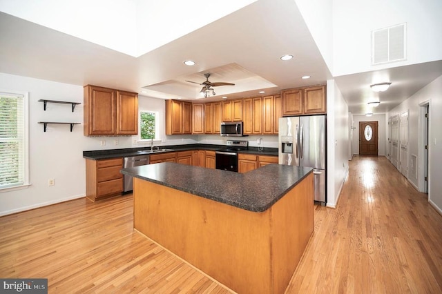 614 Yorktown Blvd, Locust Grove, VA 22508 - kitchen featuring appliances with stainless steel finishes, a tray ceiling, a sink, light wood-style floors, and baseboards