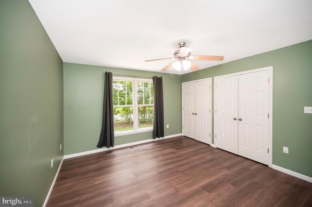 614 Yorktown Blvd, Locust Grove, VA 22508 - unfurnished bedroom with multiple closets, baseboards, and wood finished floors