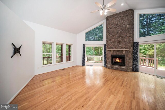 614 Yorktown Blvd, Locust Grove, VA 22508 - unfurnished living room featuring wood finished floors, a ceiling fan, high vaulted ceiling, a stone fireplace, and baseboards
