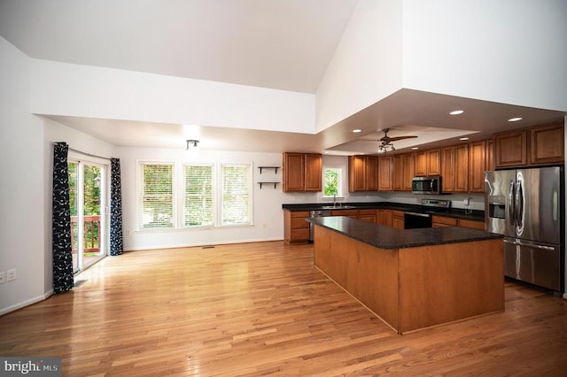614 Yorktown Blvd, Locust Grove, VA 22508 - kitchen with stainless steel appliances, a sink, dark countertops, light wood-style flooring, and a center island