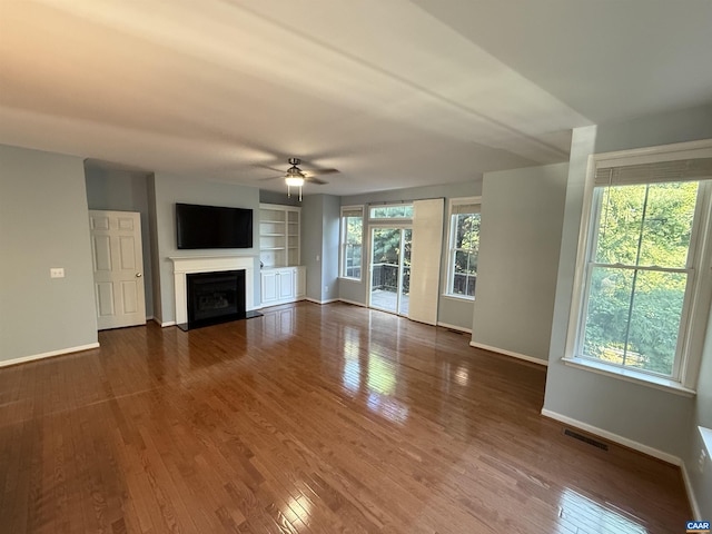 115 Melbourne Prk Cir Unit D, Charlottesville, VA 22901 - unfurnished living room with ceiling fan, a fireplace with flush hearth, and wood finished floors