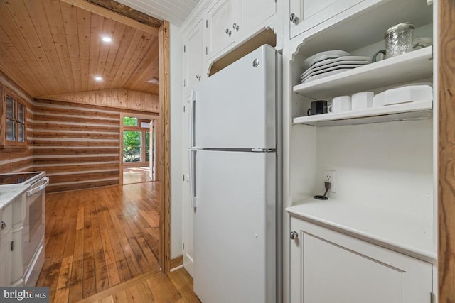 935 River Lodge Rd, Luray, VA 22835 - kitchen with white appliances, vaulted ceiling, wooden ceiling, wood-type flooring, and white cabinetry