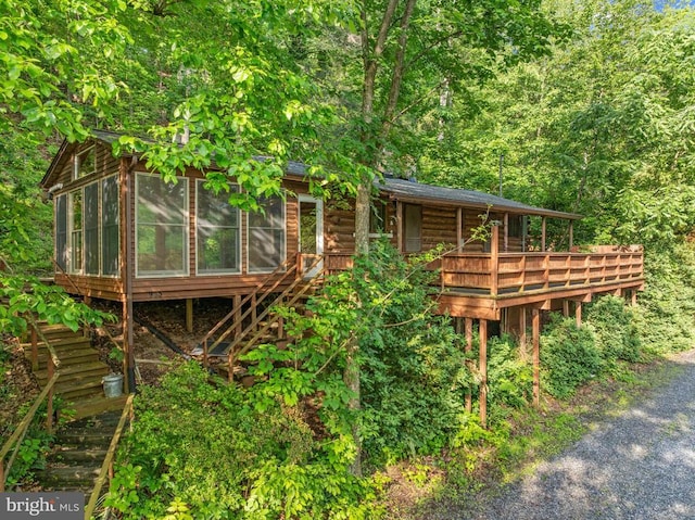 935 River Lodge Rd, Luray, VA 22835 - view of front of home with a sunroom, stairs, a wooden deck, and a view of trees