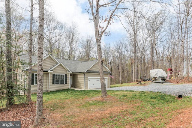 5223 Wyndemere Cir, Mineral, VA 23117 - view of front of house with a front yard, an attached garage, a shingled roof, and gravel driveway