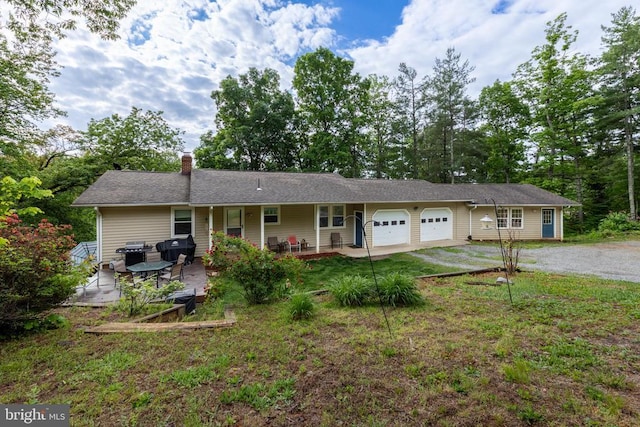 571 Cc Rd, Hood, VA 22723 - single story home featuring a garage, driveway, a chimney, a patio, and a front yard
