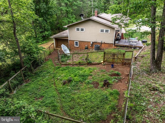 571 Cc Rd, Hood, VA 22723 - view of yard with a wooden deck, central AC unit, fence, and a wooded view