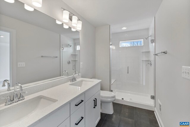 bathroom featuring tile patterned floors, a stall shower, toilet, double vanity, and recessed lighting