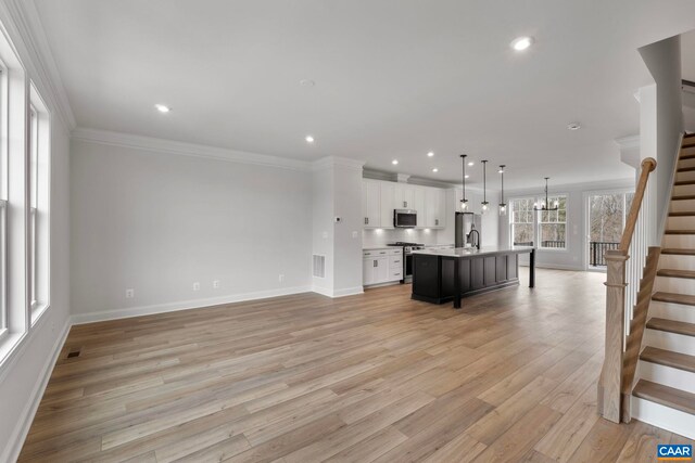 unfurnished living room featuring stairway, baseboards, recessed lighting, light wood-style flooring, and crown molding