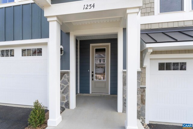 doorway to property with stone siding and board and batten siding
