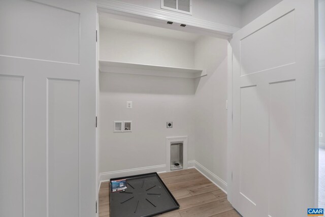 washroom with hookup for a washing machine, light wood finished floors, visible vents, hookup for an electric dryer, and laundry area