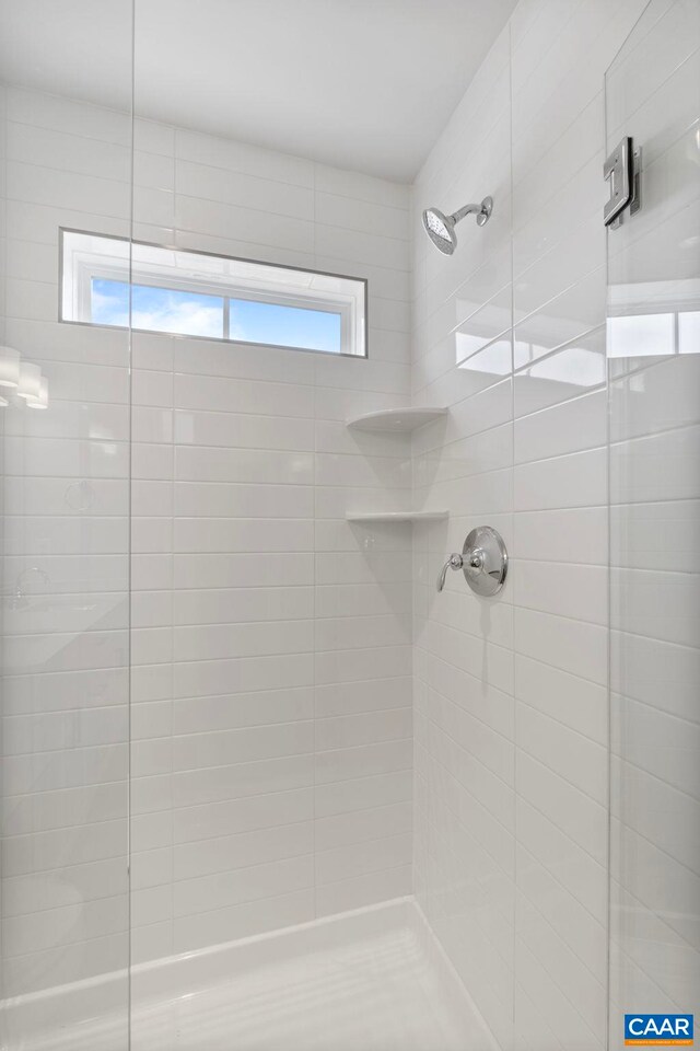 full bathroom featuring a shower stall and plenty of natural light