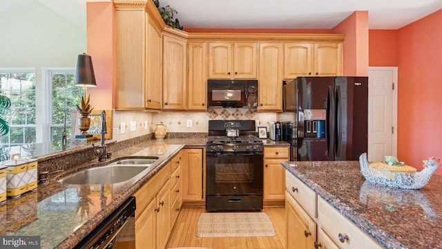 3801 Carlyle Ct, Fredericksburg, VA 22408 - kitchen with black appliances, light brown cabinets, light wood-type flooring, dark stone counters, and decorative backsplash