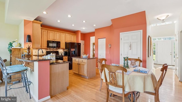 3801 Carlyle Ct, Fredericksburg, VA 22408 - kitchen with black appliances, a peninsula, backsplash, recessed lighting, and light wood-style floors
