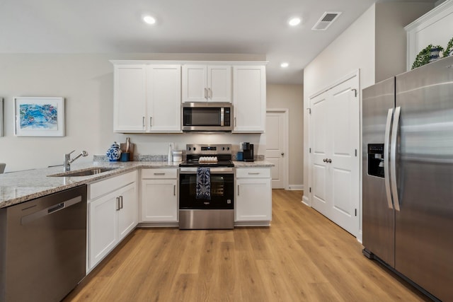 14736 Green View Dr, Elkton, VA 22827 - kitchen featuring appliances with stainless steel finishes, a sink, light wood-style flooring, white cabinetry, and recessed lighting
