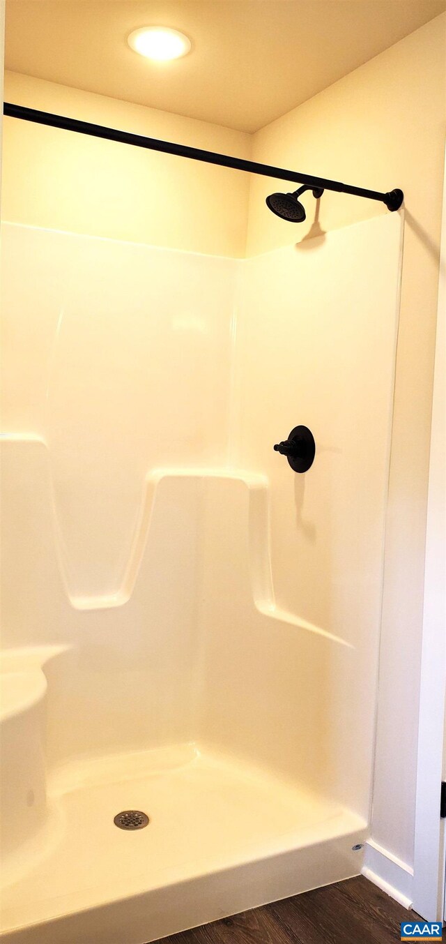 bathroom featuring hardwood / wood-style floors and a shower