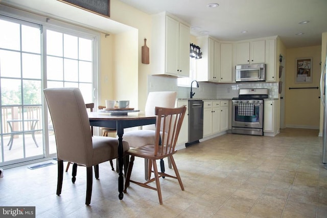 dining space featuring healthy amount of natural light, baseboards, and recessed lighting