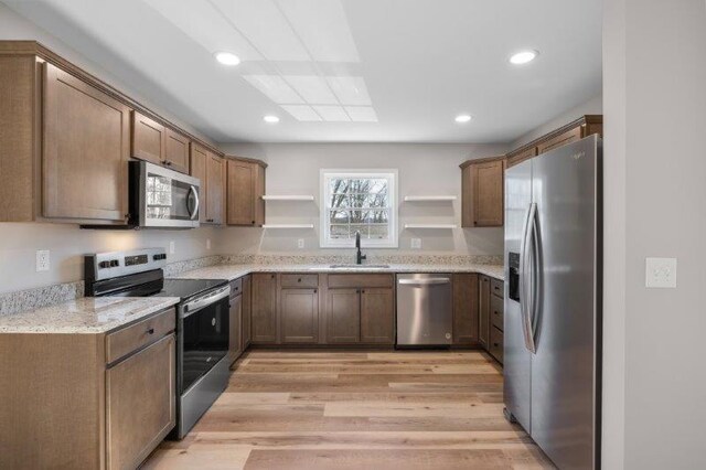 1028 D St, Waynesboro, VA 22980 - kitchen with stainless steel appliances, open shelves, a sink, light wood-style floors, and recessed lighting