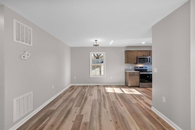 1028 D St, Waynesboro, VA 22980 - unfurnished living room featuring light wood finished floors, baseboards, and recessed lighting