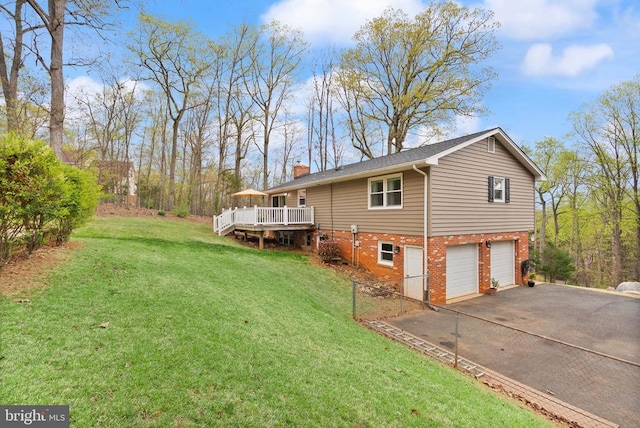  - view of property exterior with a chimney, driveway, an attached garage, a deck, and brick siding