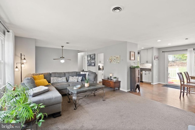  - carpeted living room with recessed lighting, ceiling fan, wood finished floors, and baseboards