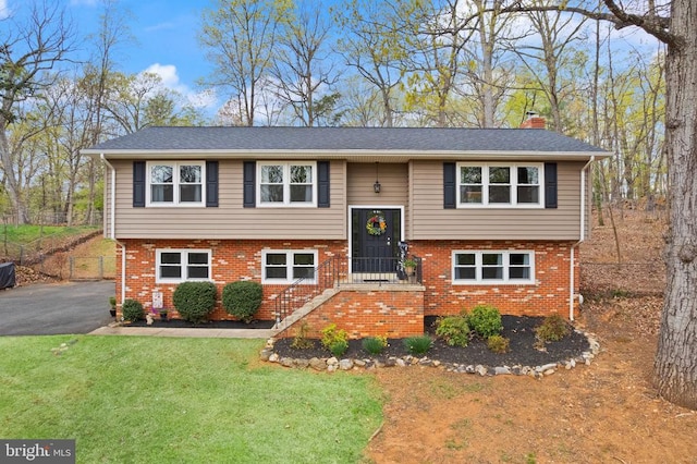  - bi-level home featuring brick siding and a chimney