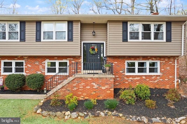 - split foyer home with brick siding and a chimney