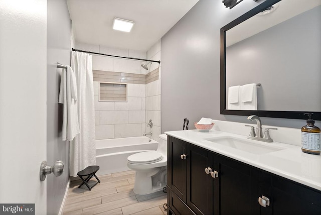  - full bathroom featuring toilet, wood finish floors, vanity, and shower / bathtub combination with curtain