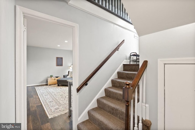  - staircase with wood finished floors and recessed lighting
